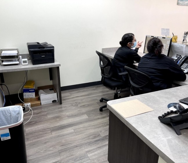 Two dental team member behind the reception desk