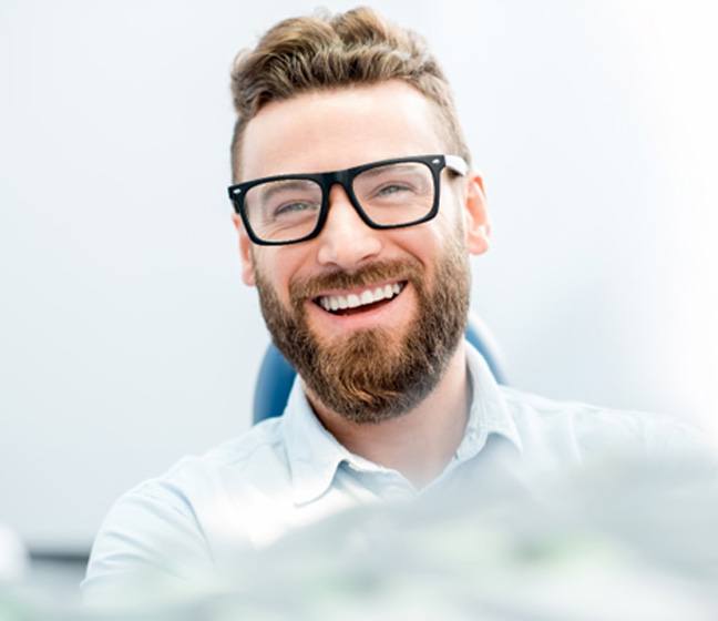 man smiling in dental chair  