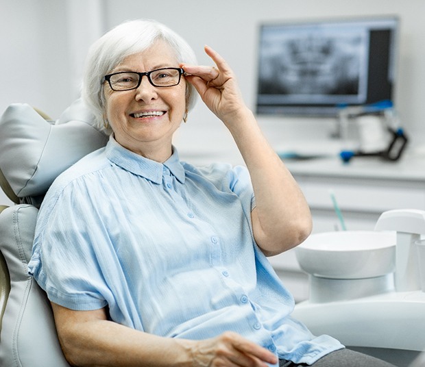 Senior woman with glasses in dental chair