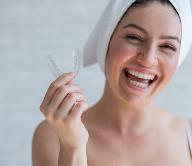 Woman smiling after using at-home dental hygiene products