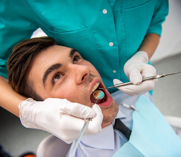 A closeup of a mouth receiving a dental checkup