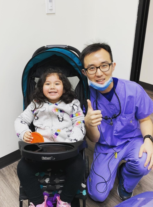 Doctor Liu at the dental office with young dental patient