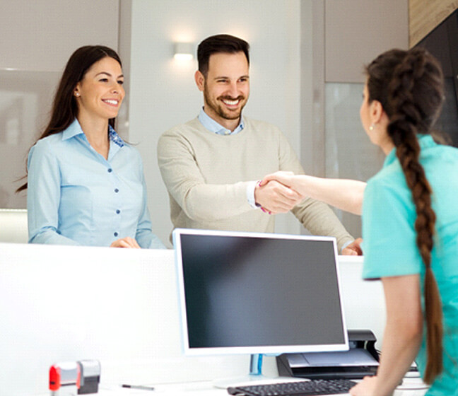 Man meeting a front desk receptionist