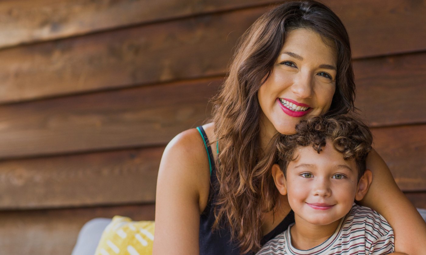 Woman smiling and holding her young son