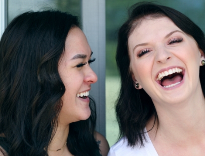 Two woman laughing together