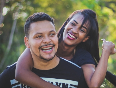 Woman hugging man from behind outdoors