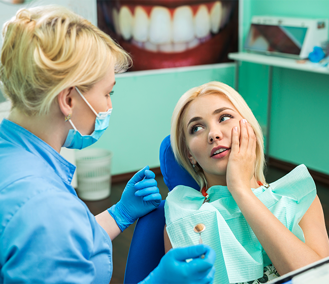 Woman visiting dentist for emergency dentistry