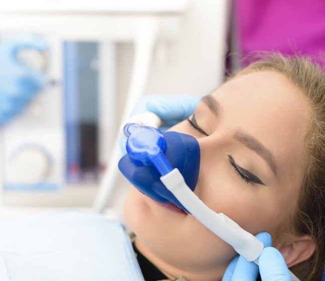 Dental patient with nitrous oxide sedation dentistry mask in place
