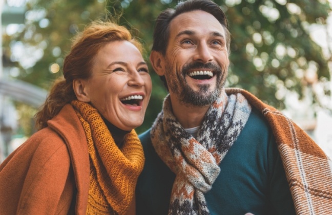 Couple with full healthy smiles after replacing missing teeht