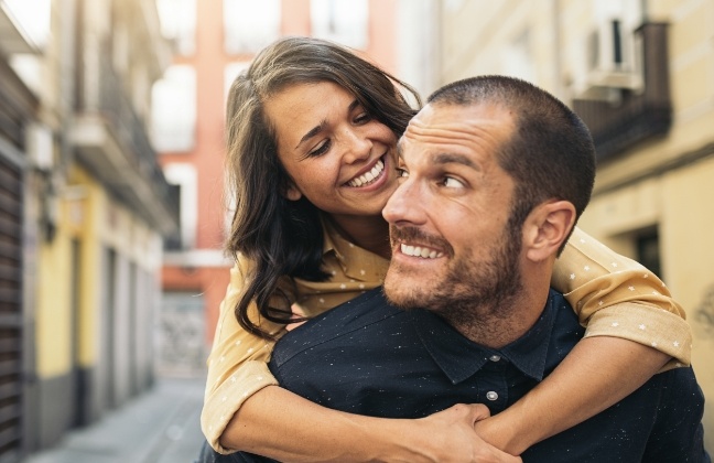 Man and woman with perfected smiles after cosmetic dentistry