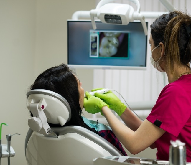 Dentist using intraoral camera to capture smile images