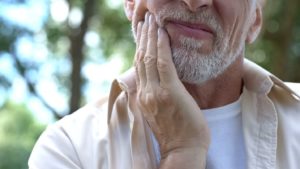 Man suffering from a toothache.