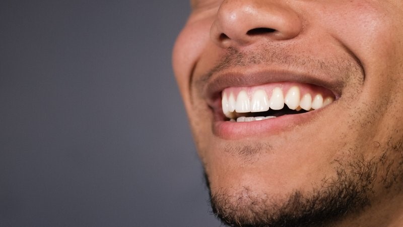 closeup of person with dental crown smiling