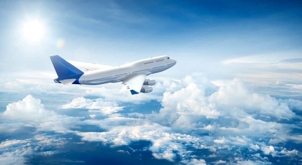 Airplane in a blue sky with white clouds